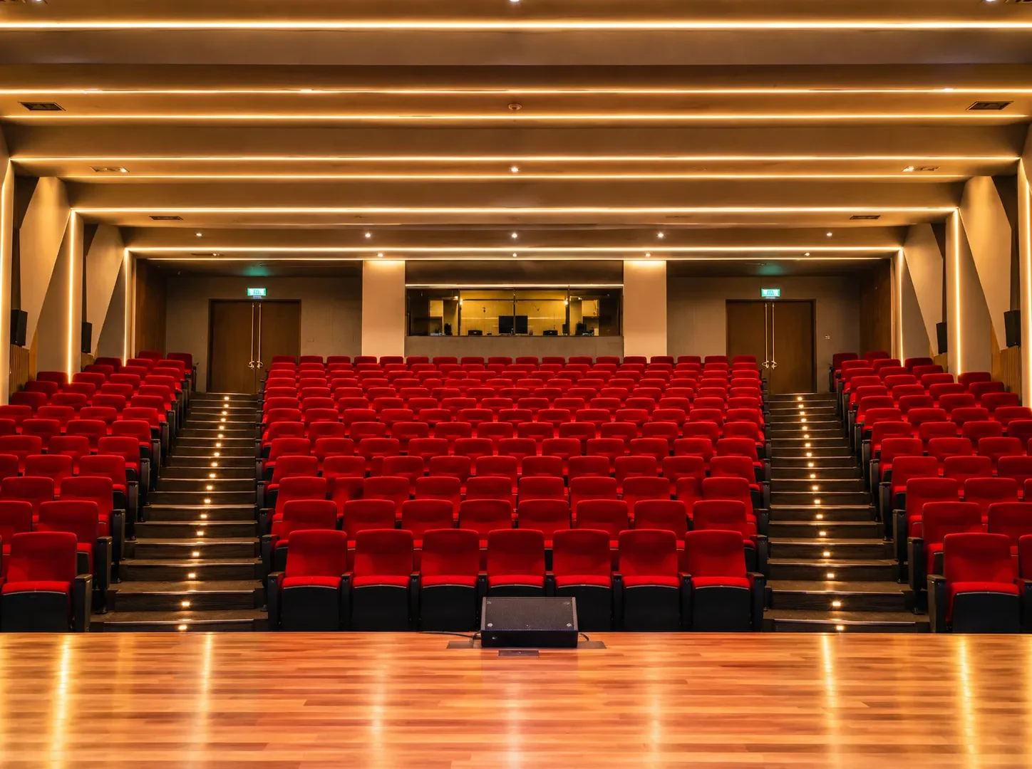 How to Plan a School PA System in Kenya: Assemblies, Classrooms and Emergency Announcements 1 School auditorium in Kenya with tiered red seating, wall-mounted speakers and a stage monitor, WNS School