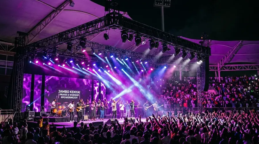 Stage lighting rig with LED fixtures and moving heads above a stage